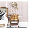Opulent Gold Bedside Table With a Delicate Rattan Shelf