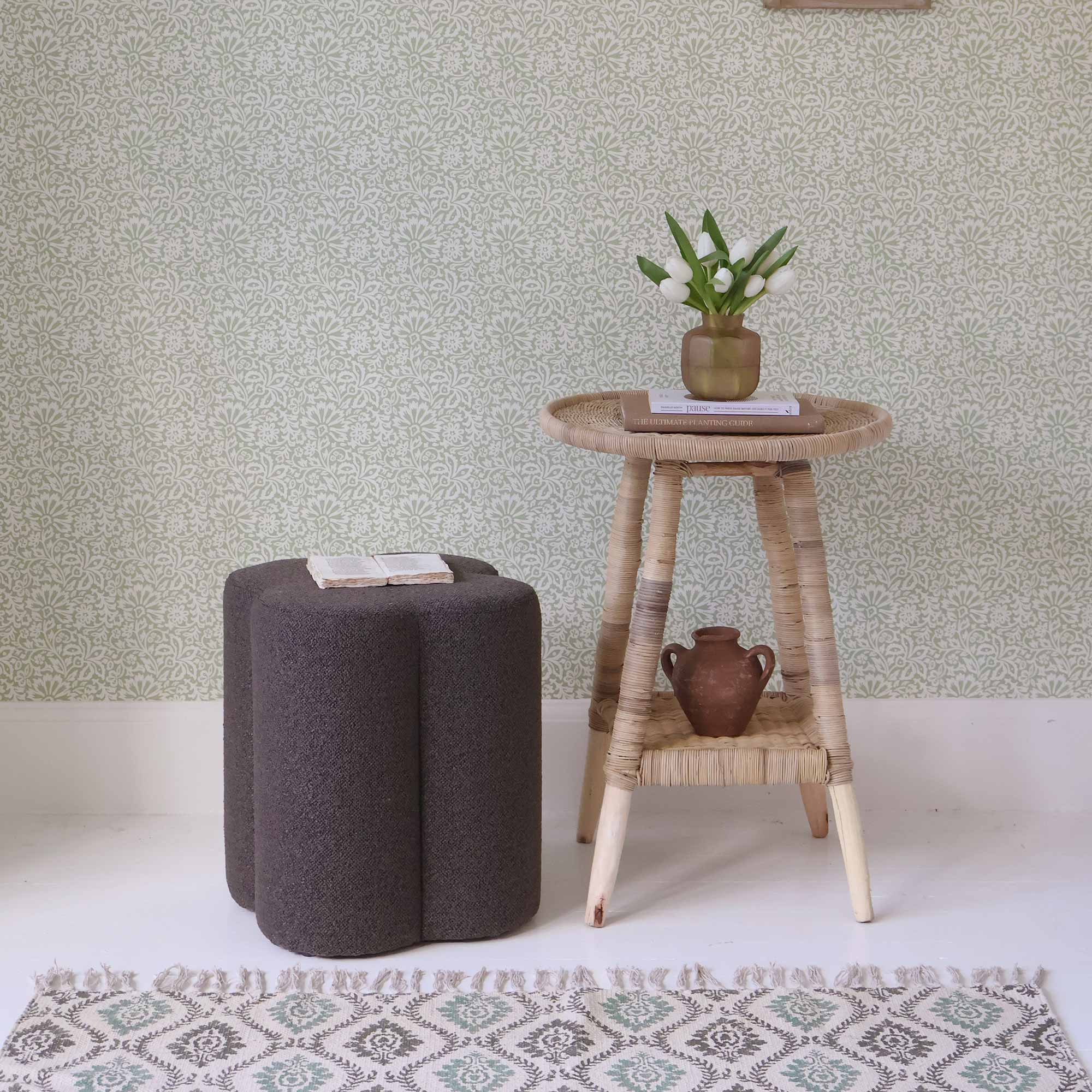 brown clover pouffe with book and side table 
