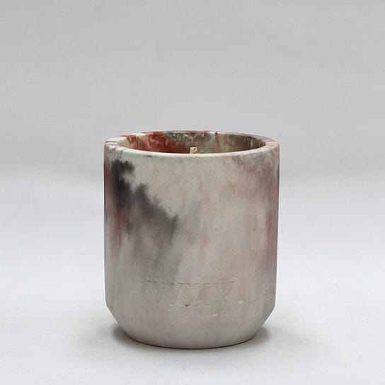 candle with an earthy-toned marble dye design candle with an earthy-toned marble dye design