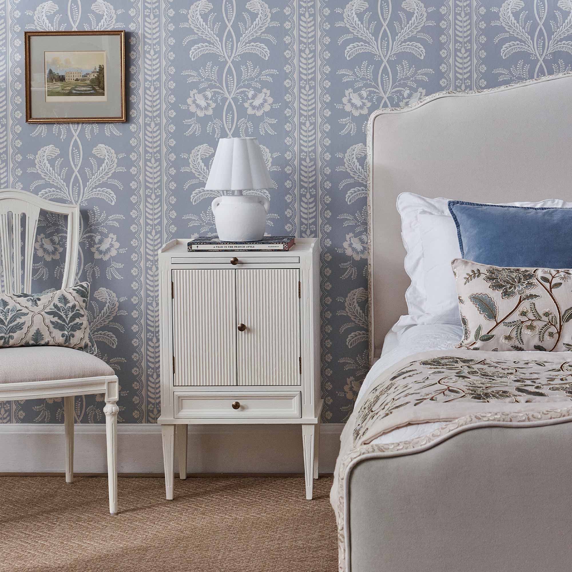 Matching white bedside table, upholstered chair and linen upholstered bed