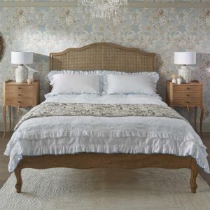 Curved Headboard Rattan Bed with White Bedding and Matching French Bedside Tables