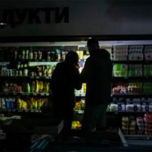 a couple shopping for groceries by flashlight
