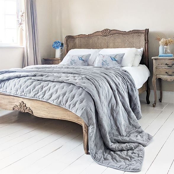 Distressed and Weathered Handmade Wooden French Bed in a Romantic Rattan Rustic Finish, dressed with a grey bedspread.