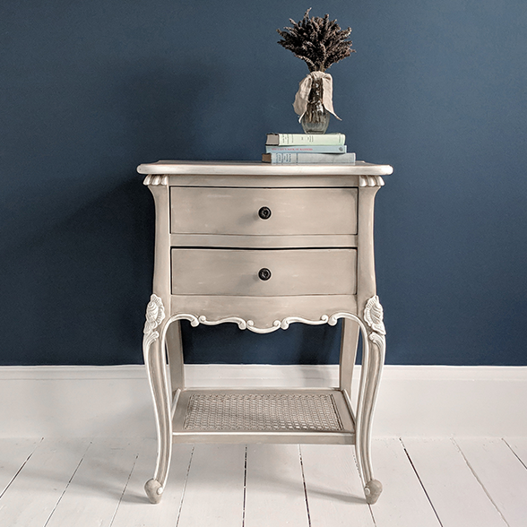 French style bedside table with 2 drawers and a rattan shelf. Painted in a fawn grey colour.
