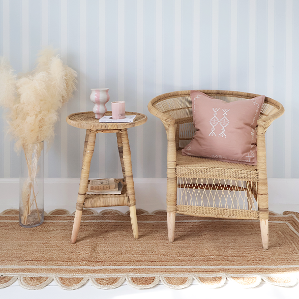 Rattan side table and chair styled atop a jute rug. 
